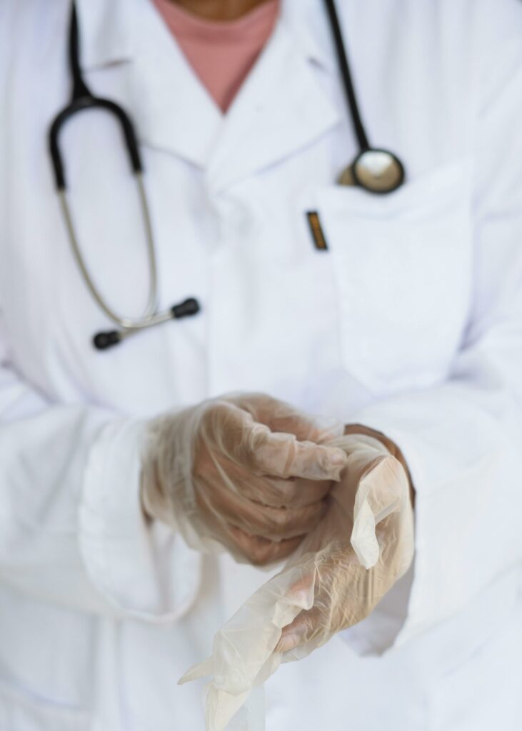 healthcare worker putting on gloves